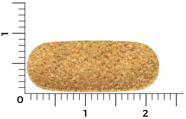 Une pilule Vitakruid – Multi Jour, d’un peu plus de deux centimètres de long, repose sur une surface avec une échelle de mesure visible.
